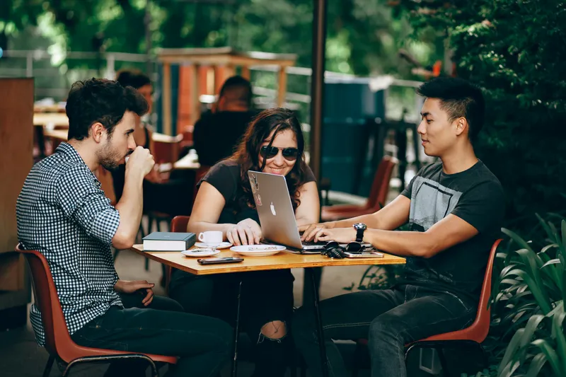 Team members having a catch-up meeting in an outdoor setting